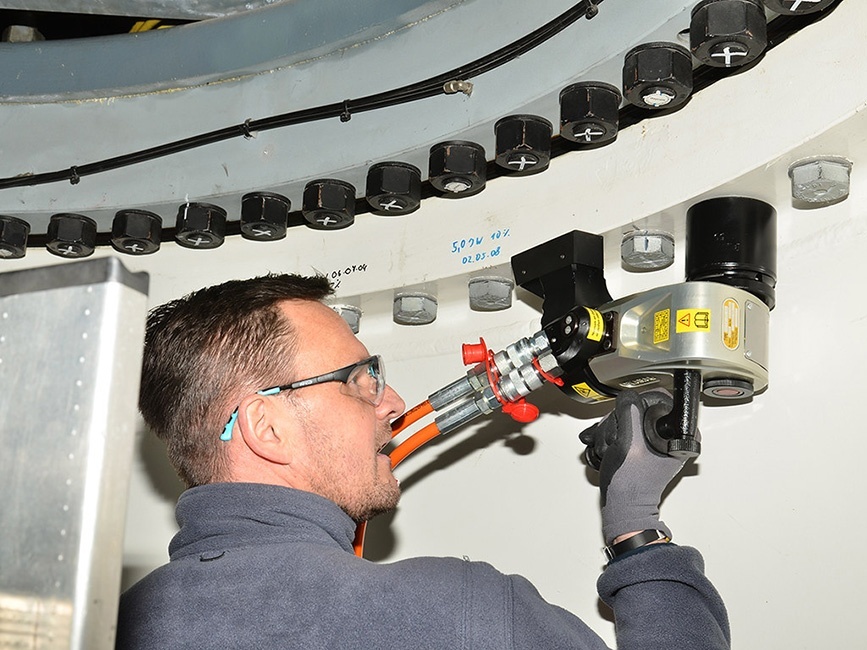 a man using a hydraulic bolting tool